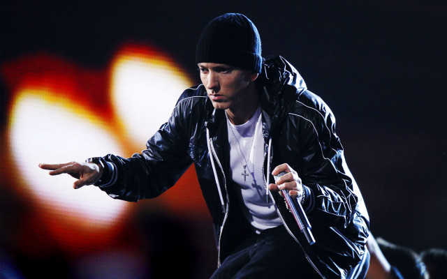 Man holding microphone stage bright free wallpaper - medium preview image