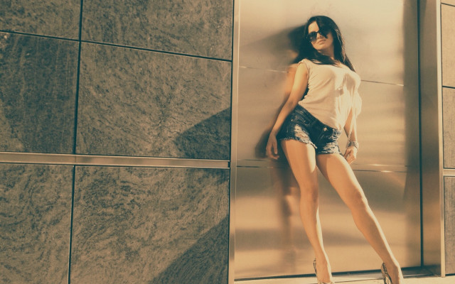 Woman leaning wall heels denim free wallpaper - medium preview image