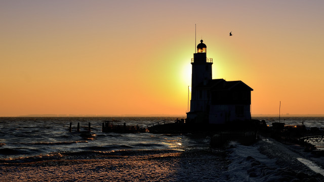 Lighthouse beach sunset waves boat free wallpaper - medium preview image