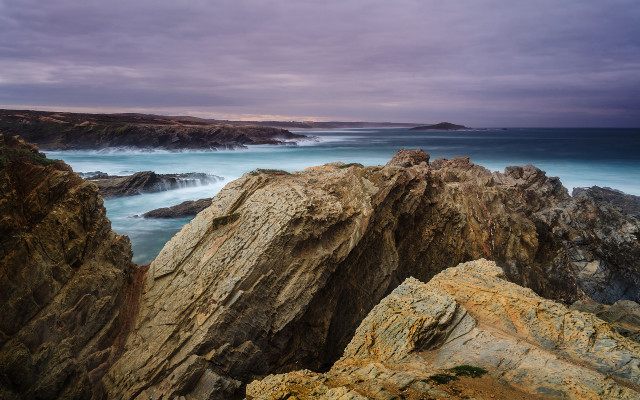 Rocky cliff water cloudy sky free wallpaper - medium preview image