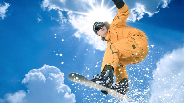 Snowboarder orange jacket air trick free wallpaper - medium preview image