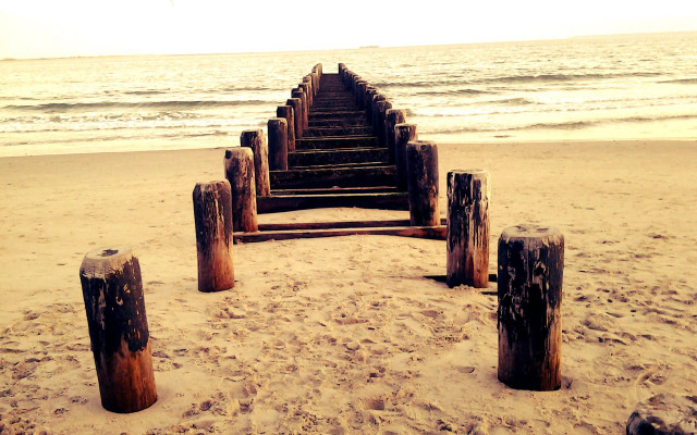 Wooden posts beach waves sunset free wallpaper - medium preview image