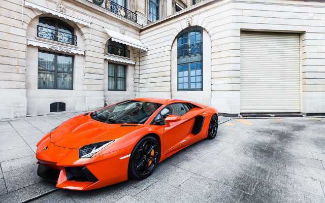 Bright orange sports car building free wallpaper - medium preview image