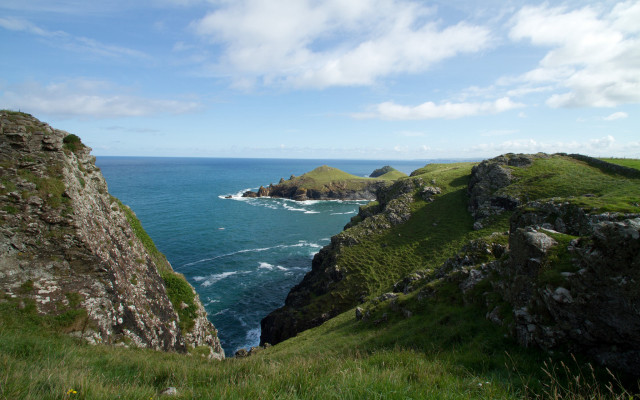 Grassy hill rocky cliff island free wallpaper - medium preview image