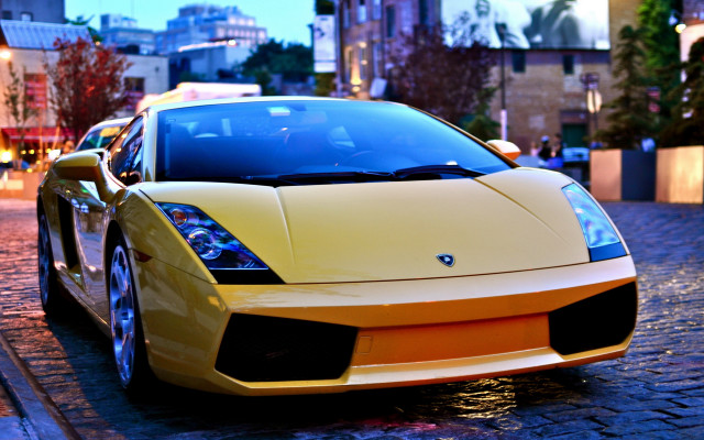 Yellow sports car city dusk free wallpaper - medium preview image