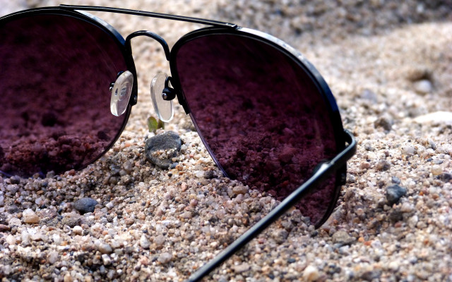 Sunglasses beach rocks pebbles blurry free wallpaper - medium preview image