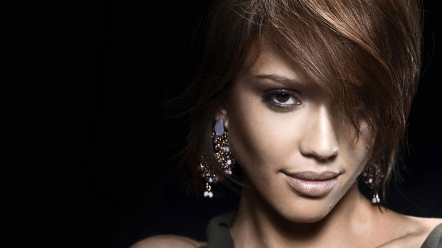Woman shortcut hair earrings serious free wallpaper - medium preview image