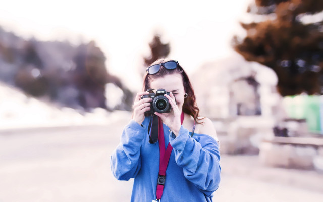 Woman camera snowy street blurry free wallpaper - medium preview image