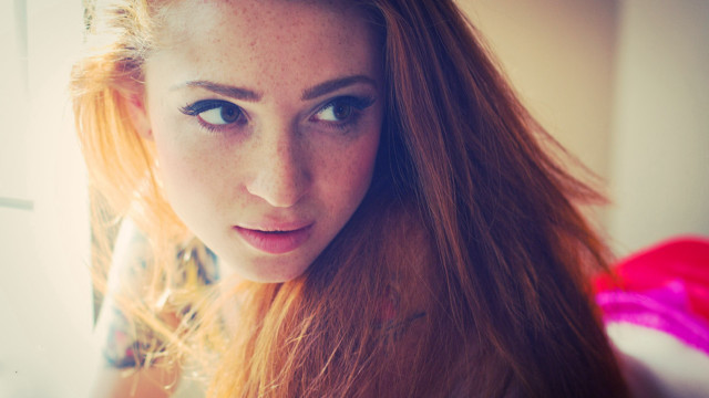 Woman red hair serious look free wallpaper - medium preview image