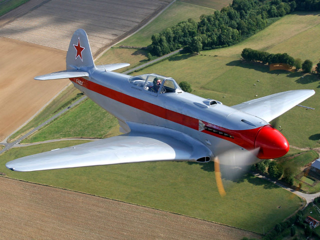 Red white airplane over green free wallpaper - medium preview image