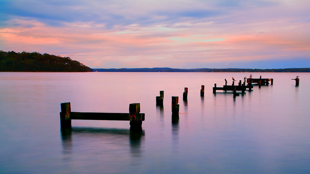 Wooden posts lake sunset boat free wallpaper - medium preview image
