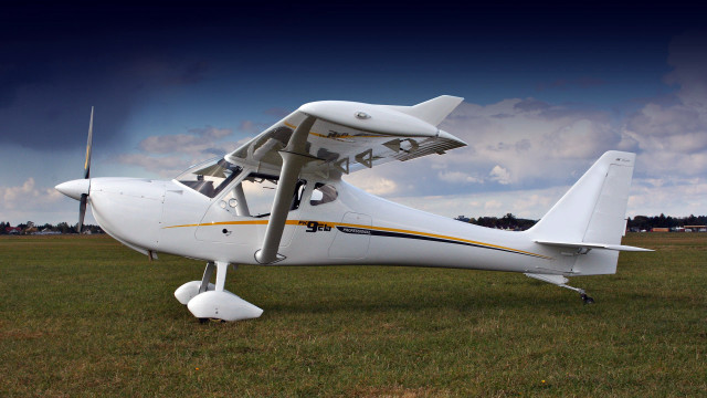 White airplane grass field wind free wallpaper - medium preview image
