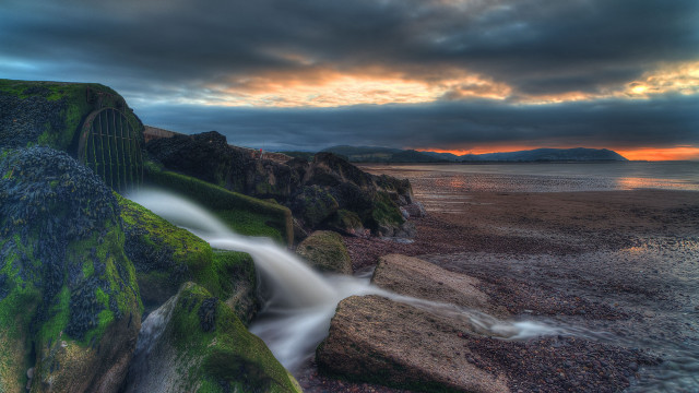 Waterfall rocky cliff sunset reflection free wallpaper - medium preview image