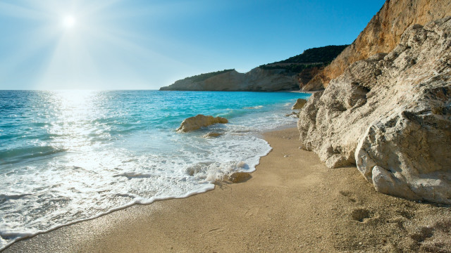 Sandy beach rock cliff blue free wallpaper - medium preview image