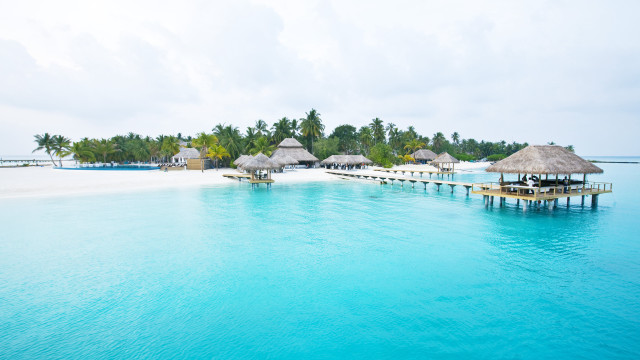 Beach pier thatched huts lagoon free wallpaper - medium preview image