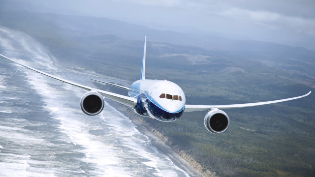 Large jetliner over hills and free wallpaper - medium preview image