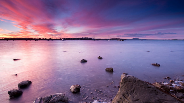 Sunset ocean rocks distant island free wallpaper - medium preview image