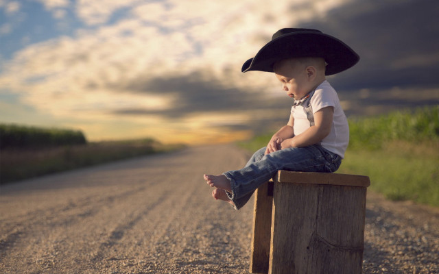 Boy hat sitting beach sunset free wallpaper - medium preview image