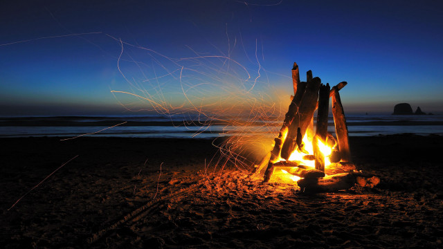 Campfire beach rock formation sunset free wallpaper - medium preview image
