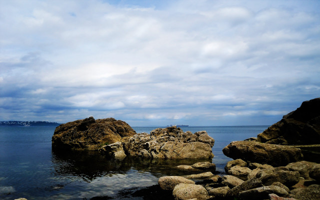 Person rock water boat sky free wallpaper - medium preview image
