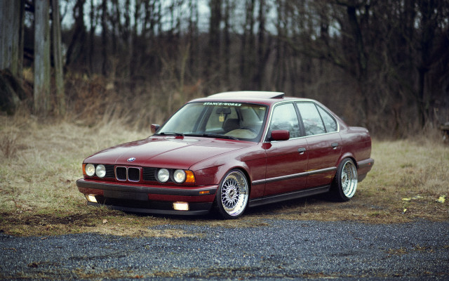 Red car parked field forest free wallpaper - medium preview image