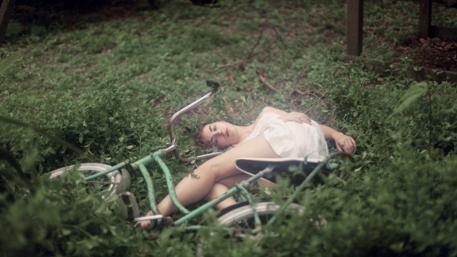 Woman bike grass overgrown nature free wallpaper - medium preview image