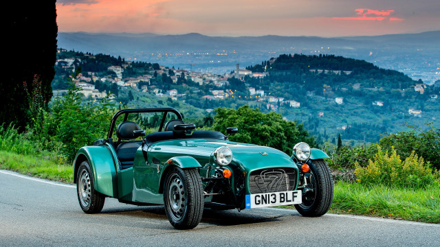 Green sports car city hills free wallpaper - medium preview image