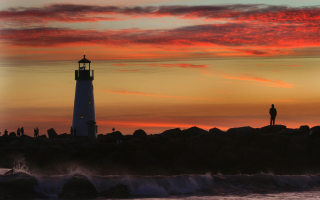 Lighthouse sunset rocks silhouette ocean free wallpaper - medium preview image