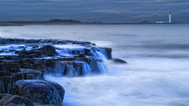 Lighthouse waves rocks beach cloudy free wallpaper - medium preview image