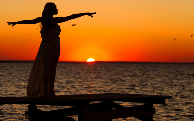 Woman dock sunset outstretched arms free wallpaper - medium preview image