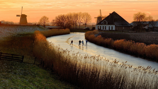 Skating river sunset windmills town free wallpaper - medium preview image