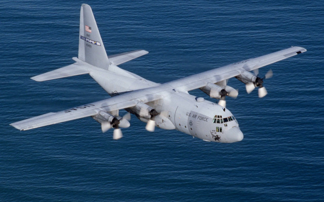 Large airplane over ocean landing free wallpaper - medium preview image