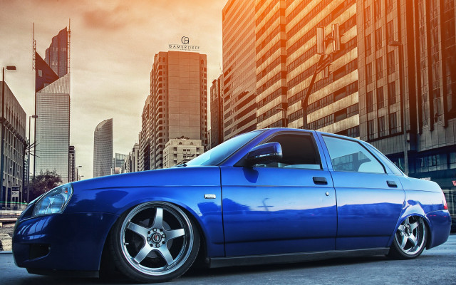 Blue car tall building cloudy free wallpaper - medium preview image