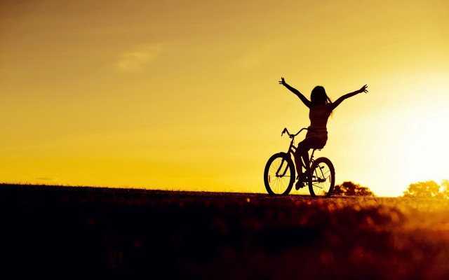 Sunset biker arms outstretched hill free wallpaper - medium preview image