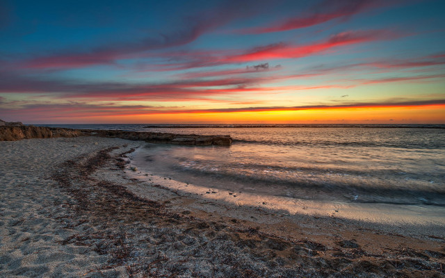 Beach sunset rocky shore cliff free wallpaper for desktop - medium preview image