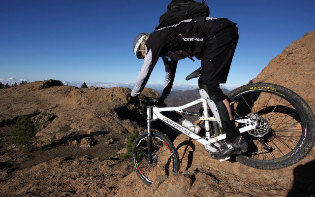 Man riding mountain bike rocky free wallpaper - medium preview image