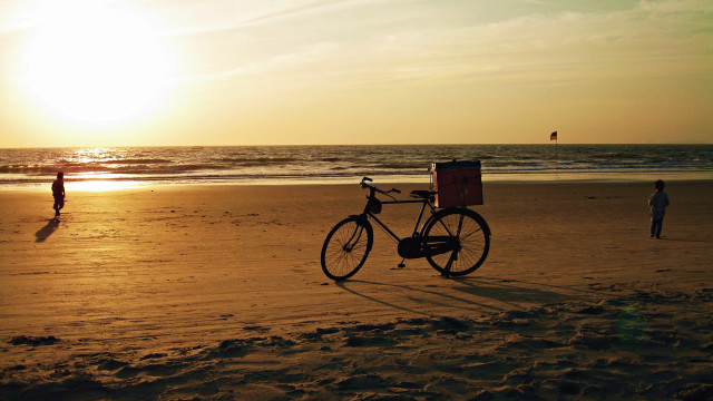 Bike beach person sunset ocean free wallpaper - medium preview image