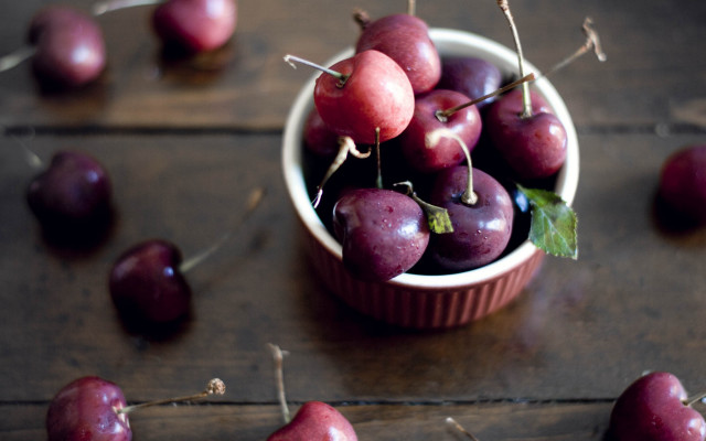 Bowl of plums on wooden free wallpaper - medium preview image