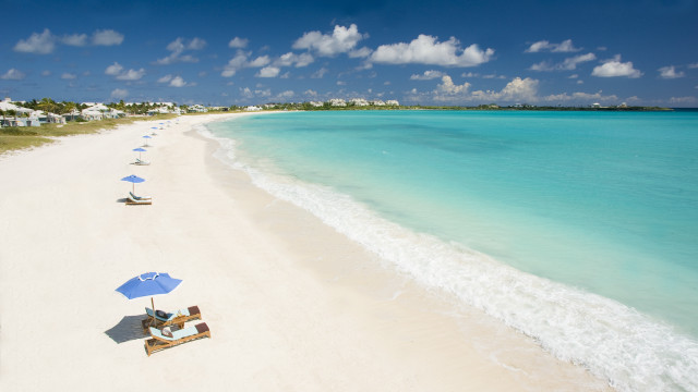 Beach chairs umbrellas sky houses free wallpaper - medium preview image