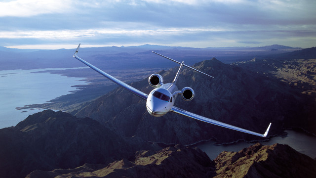 Small plane over mountains lake free wallpaper - medium preview image