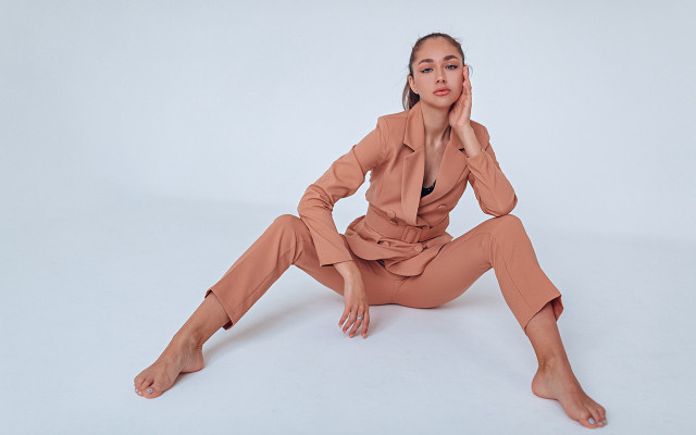 Woman tan suit sitting portrait free wallpaper - medium preview image