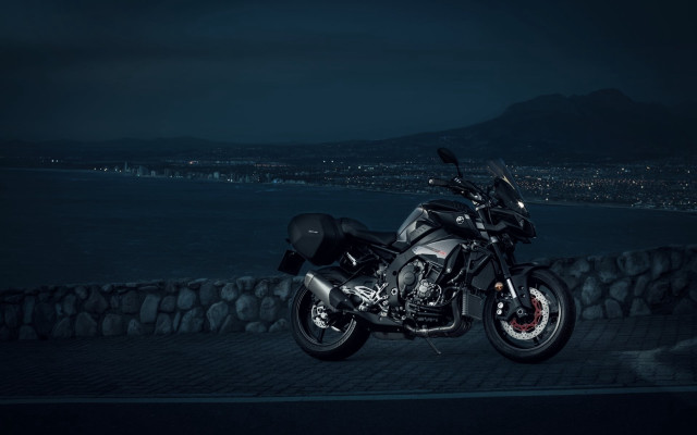 Motorcycle cobblestone night city water free wallpaper - medium preview image