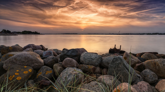 Sunset lake rocks grass boat free wallpaper - medium preview image