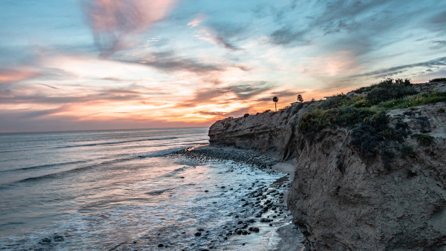 Beach cliff sunset water reflection free wallpaper - medium preview image