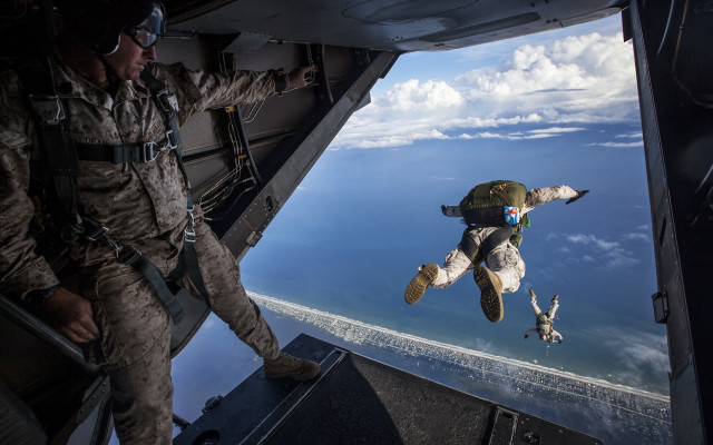 Military man flying stuffed animal free wallpaper - medium preview image