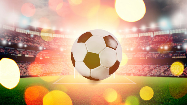 Soccer ball flying over grass free wallpaper - medium preview image