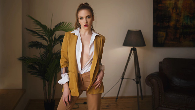 Woman yellow jacket tan pants free wallpaper - medium preview image