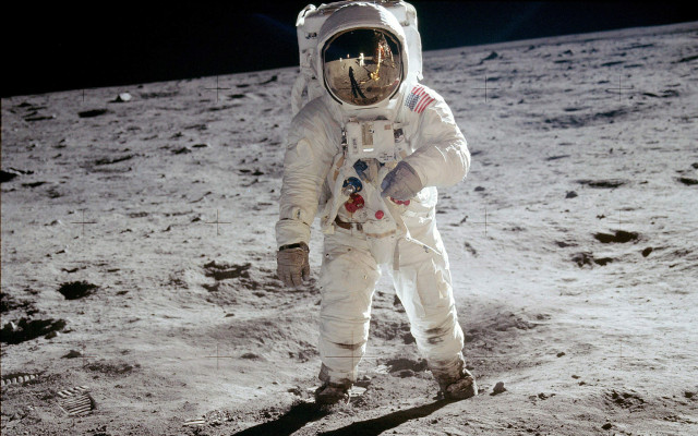 Astronaut walking on moon arm free wallpaper - medium preview image