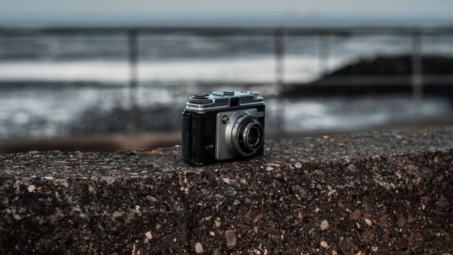Camera ledge ocean fenced water free wallpaper - medium preview image
