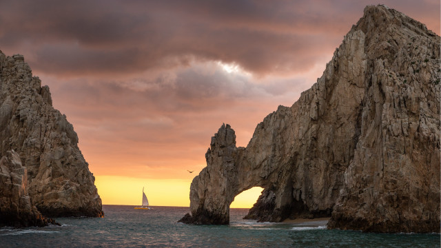 Sailboat rocks ocean sunset landscape free wallpaper - medium preview image